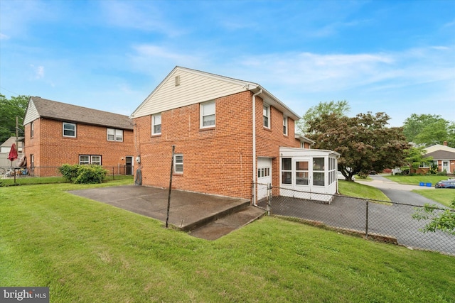 2904 Armstrong Ave, Secane, PA 19018 - back of property with a patio, a sunroom, brick siding, and a garage