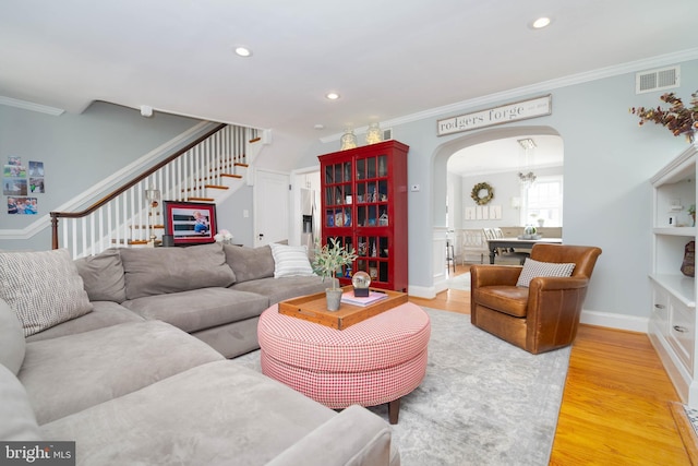 409 Regester Ave, Baltimore, MD 21212 - living area with arched walkways, ornamental molding, stairway, light wood-style floors, and recessed lighting