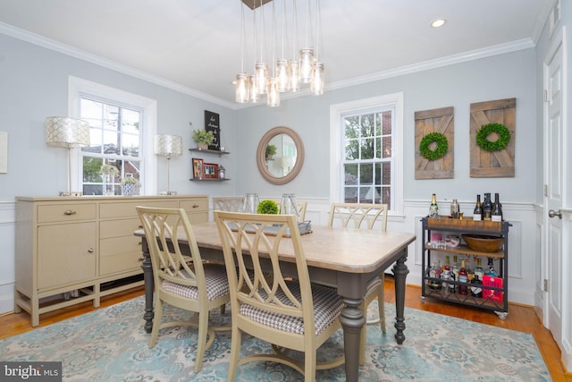 409 Regester Ave, Baltimore, MD 21212 - dining area with light wood-type flooring, ornamental molding, healthy amount of natural light, a chandelier, and a wainscoted wall