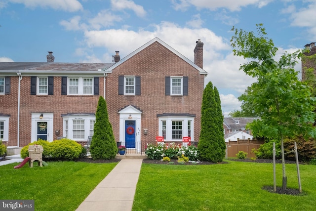 409 Regester Ave, Baltimore, MD 21212 - view of front of property featuring a chimney and brick siding