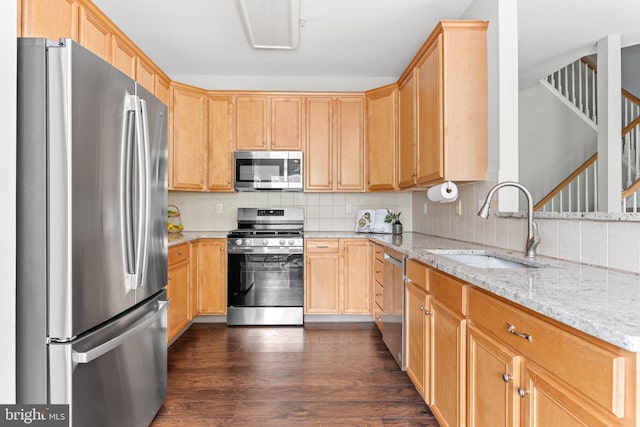119 Fringetree Dr, West Chester, PA 19380 - kitchen featuring appliances with stainless steel finishes, a sink, light stone countertops, and decorative backsplash