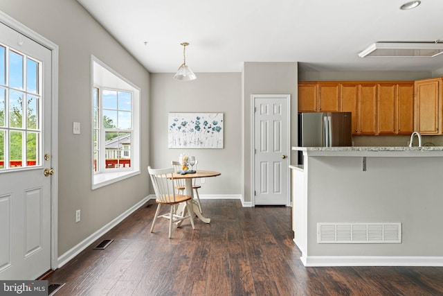 119 Fringetree Dr, West Chester, PA 19380 - kitchen featuring freestanding refrigerator, dark wood finished floors, baseboards, and brown cabinets
