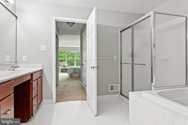 119 Fringetree Dr, West Chester, PA 19380 - bathroom featuring vanity, ensuite bathroom, a stall shower, a garden tub, and tile patterned floors