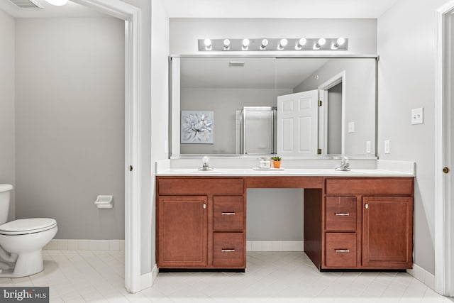 119 Fringetree Dr, West Chester, PA 19380 - full bathroom featuring double vanity, toilet, tile patterned flooring, a shower with shower door, and baseboards