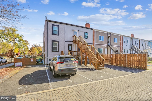 200 Hamilton St NW Unit 2, Washington, DC 20011 - view of front of property featuring uncovered parking, stairs, a residential view, a chimney, and brick siding