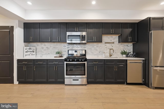 200 Hamilton St NW Unit 2, Washington, DC 20011 - kitchen with appliances with stainless steel finishes, a sink, light countertops, light wood-style flooring, and recessed lighting