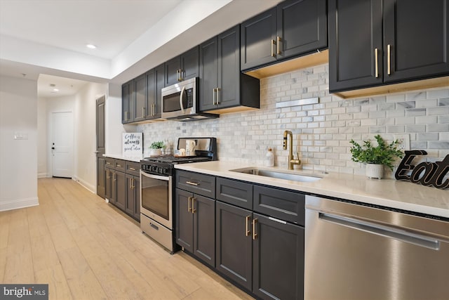 200 Hamilton St NW Unit 2, Washington, DC 20011 - kitchen with appliances with stainless steel finishes, a sink, light countertops, tasteful backsplash, and recessed lighting