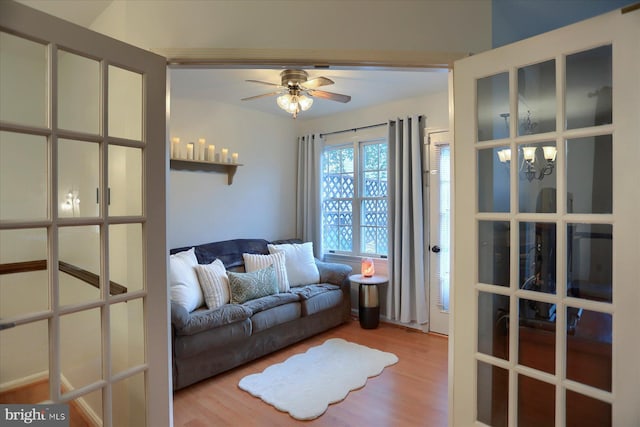 2217 Highland Cir, Harrisburg, PA 17110 - living area featuring wood finished floors, a ceiling fan, and a chandelier
