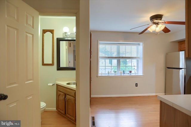 2217 Highland Cir, Harrisburg, PA 17110 - bathroom featuring vanity, wood finished floors, a ceiling fan, toilet, and baseboards