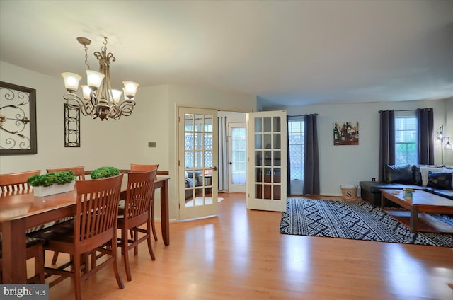 2217 Highland Cir, Harrisburg, PA 17110 - dining room featuring light wood-style floors, a chandelier, and french doors
