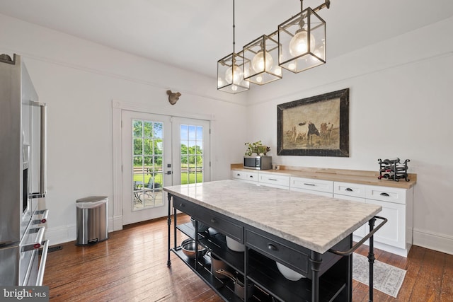 23350 Cedar Mountain Dr, Rapidan, VA 22733 - kitchen with stainless steel microwave, white cabinets, french doors, dark wood-style flooring, and hanging light fixtures