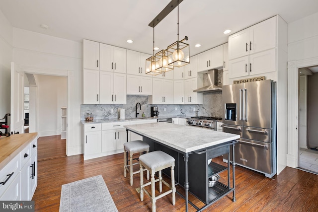 23350 Cedar Mountain Dr, Rapidan, VA 22733 - kitchen featuring appliances with stainless steel finishes, wall chimney range hood, a sink, white cabinets, and recessed lighting