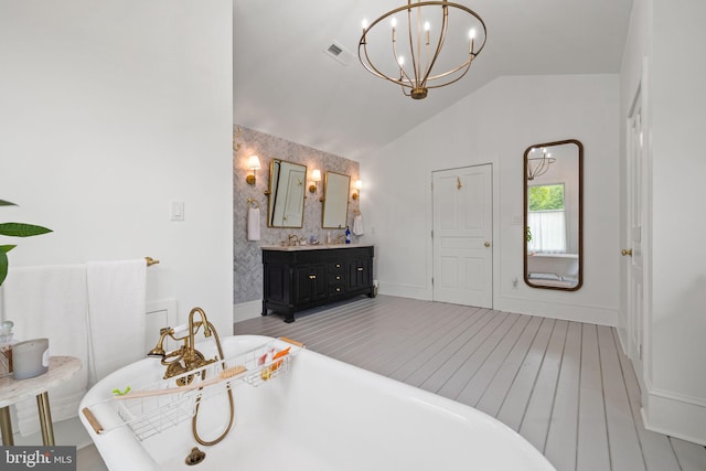 23350 Cedar Mountain Dr, Rapidan, VA 22733 - full bath with double vanity, a freestanding tub, lofted ceiling, a chandelier, and wood finished floors