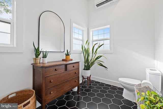 23350 Cedar Mountain Dr, Rapidan, VA 22733 - half bath with toilet, a wall mounted air conditioner, baseboards, and tile patterned flooring