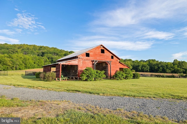 23350 Cedar Mountain Dr, Rapidan, VA 22733 - view of home's exterior featuring a garage, an outbuilding, and a view of trees
