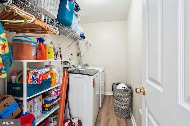22953 Fleet Ter, Sterling, VA 20166 - laundry area featuring washing machine and dryer, wood finished floors, and baseboards