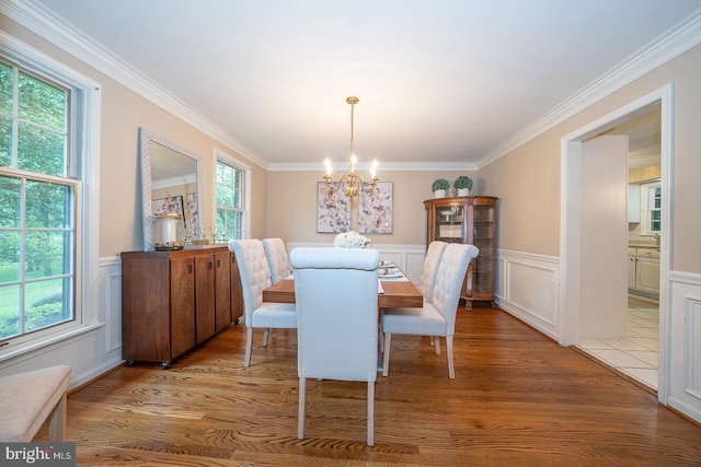 849 Milmar Rd, Newtown Square, PA 19073 - dining space with a chandelier, ornamental molding, a wainscoted wall, wood finished floors, and a decorative wall