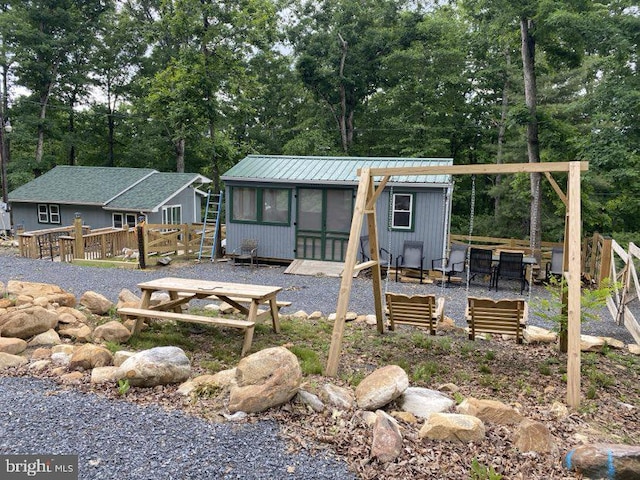 14 Johns Rd, Augusta, WV 26704 - rear view of property featuring metal roof, view of scattered trees, and a deck