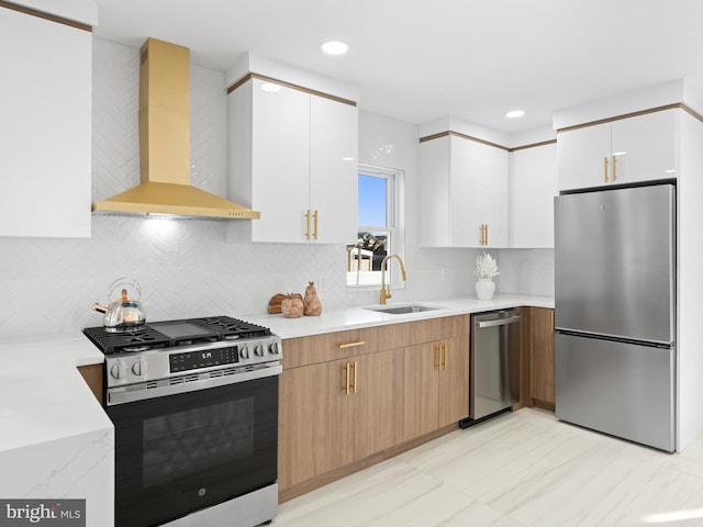 212 W 13th Ave, Wildwood, NJ 08260 - kitchen with appliances with stainless steel finishes, wall chimney exhaust hood, a sink, white cabinets, and decorative backsplash
