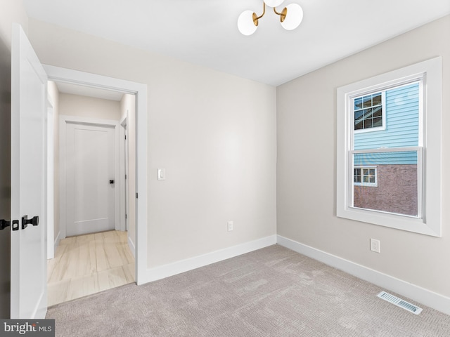 212 W 13th Ave, Wildwood, NJ 08260 - spare room featuring carpet flooring, baseboards, and a chandelier