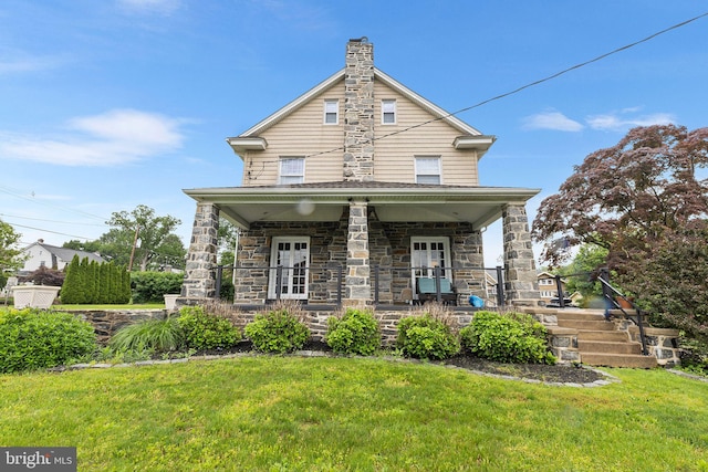 225 Wayne Ave, Lansdowne, PA 19050 - view of front of property with a porch, a front yard, and stone siding