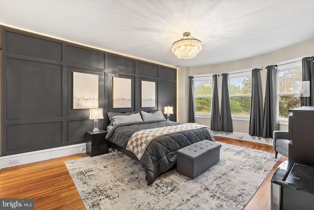 225 Wayne Ave, Lansdowne, PA 19050 - bedroom featuring a chandelier, wood finished floors, a decorative wall, and baseboards