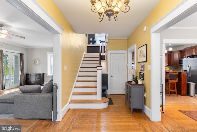 225 Wayne Ave, Lansdowne, PA 19050 - stairway with wood-type flooring, a chandelier, a ceiling fan, ornamental molding, and baseboards