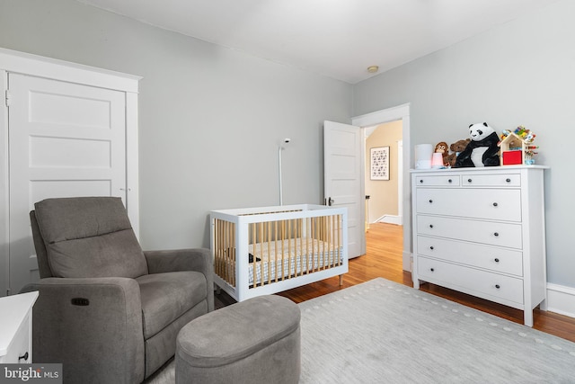 225 Wayne Ave, Lansdowne, PA 19050 - bedroom with wood finished floors, a nursery area, and baseboards