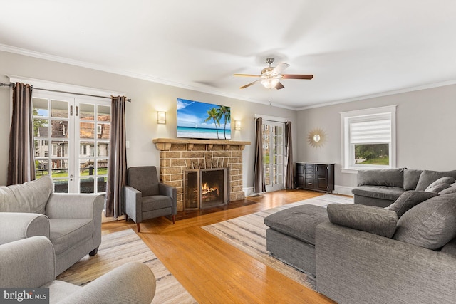 225 Wayne Ave, Lansdowne, PA 19050 - living area featuring wood finished floors, ornamental molding, a fireplace, and ceiling fan