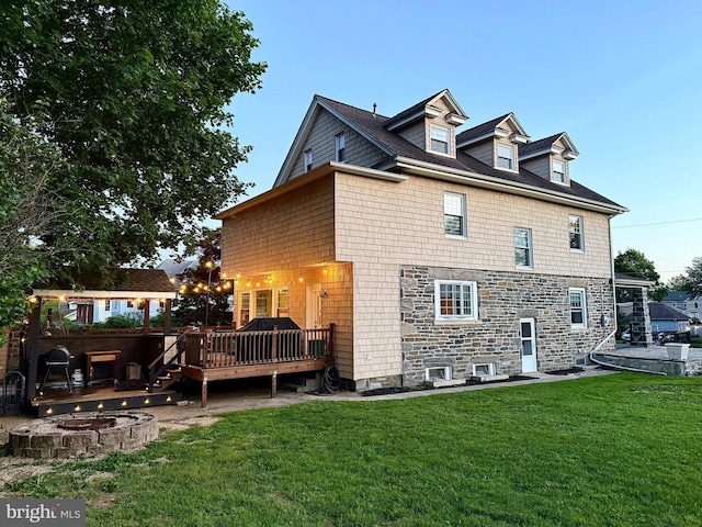 225 Wayne Ave, Lansdowne, PA 19050 - back of property with an outdoor fire pit, a deck, stone siding, and a yard