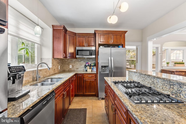 225 Wayne Ave, Lansdowne, PA 19050 - kitchen featuring a sink, stainless steel appliances, backsplash, pendant lighting, and light stone counters