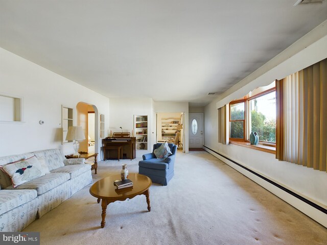 834 Amboy Ave, Edison, NJ 08837 - living room with a baseboard heating unit, light colored carpet, and arched walkways