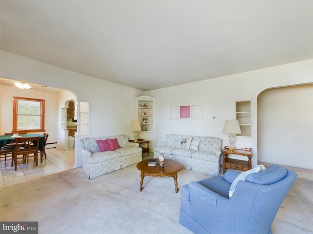 834 Amboy Ave, Edison, NJ 08837 - living area with arched walkways, carpet, tile patterned floors, baseboard heating, and built in shelves
