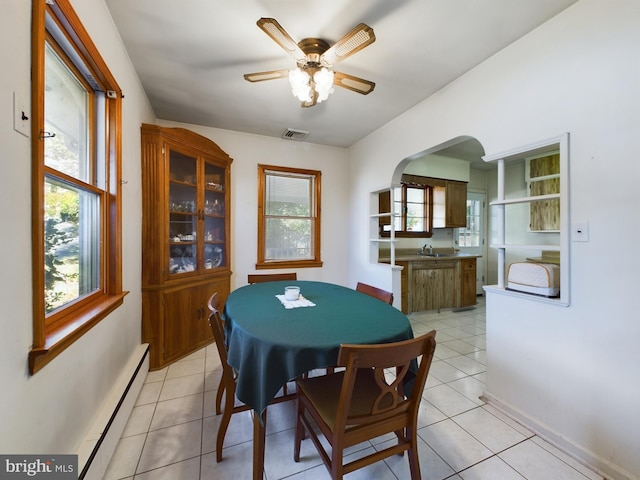 834 Amboy Ave, Edison, NJ 08837 - dining room with a ceiling fan, light tile patterned floors, arched walkways, and baseboard heating