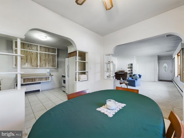 834 Amboy Ave, Edison, NJ 08837 - dining area with arched walkways, radiator, light tile patterned floors, and baseboard heating