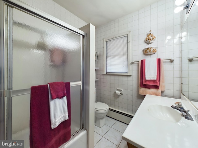 834 Amboy Ave, Edison, NJ 08837 - full bath featuring a baseboard heating unit, tile walls, tile patterned floors, vanity, and toilet