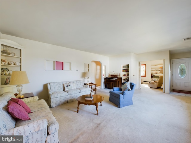 834 Amboy Ave, Edison, NJ 08837 - living area with carpet, arched walkways, and baseboard heating