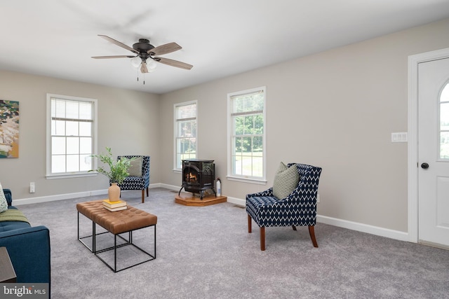 11307 Urieville Ln, Worton, MD 21678 - sitting room with a wood stove, a ceiling fan, and healthy amount of natural light