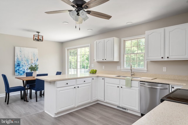 11307 Urieville Ln, Worton, MD 21678 - kitchen with dishwasher, a sink, a peninsula, white cabinetry, and light wood-style flooring