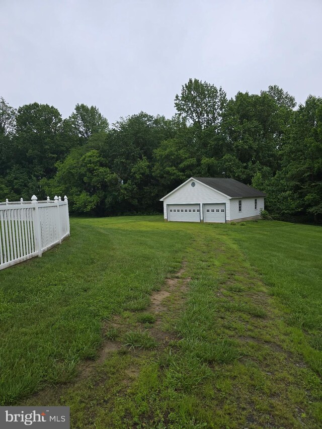 11307 Urieville Ln, Worton, MD 21678 - view of yard with a detached garage, a view of trees, and an outbuilding