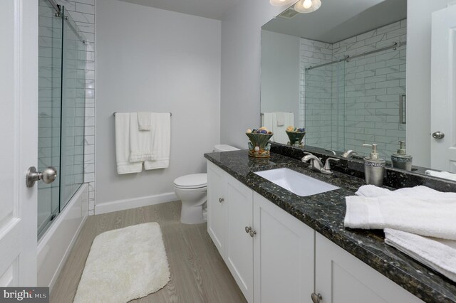 61 Grand Banks Cir, Marlton, NJ 08053 - bathroom featuring toilet, wood finished floors, vanity, bath / shower combo with glass door, and baseboards