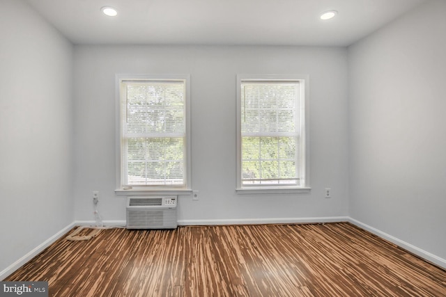 2605 Magdalene Acres Pl, Waldorf, MD 20603 - empty room with baseboards, a wall mounted AC, dark wood-type flooring, plenty of natural light, and recessed lighting