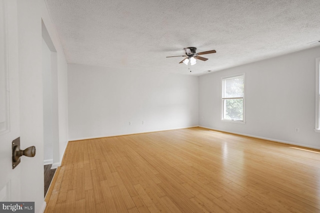2605 Magdalene Acres Pl, Waldorf, MD 20603 - unfurnished room with light wood-style flooring, a ceiling fan, a textured ceiling, and baseboards