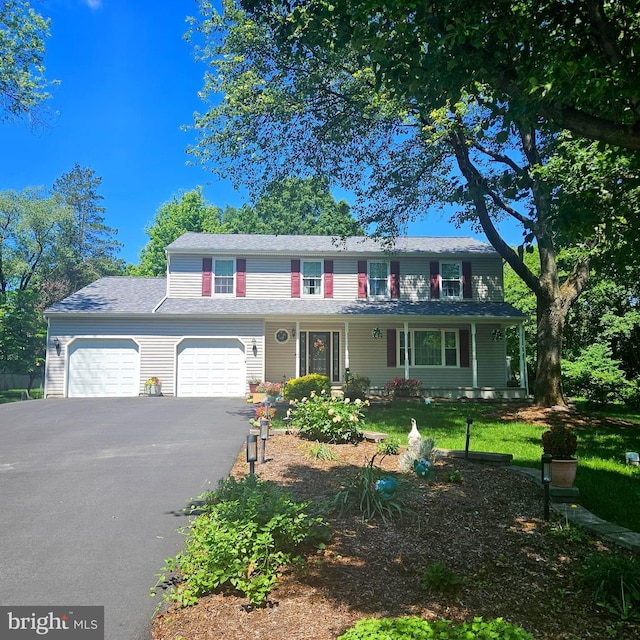 9202 Stone Spring Ln, Pasadena, MD 21122 - view of front of home with asphalt driveway, an attached garage, a front lawn, and a porch