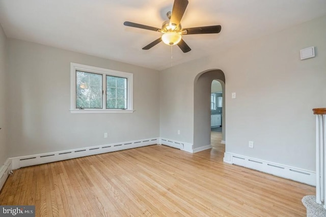531 Jessamine Ave, Collingswood, NJ 08107 - unfurnished room with baseboard heating, arched walkways, a ceiling fan, and light wood-style floors