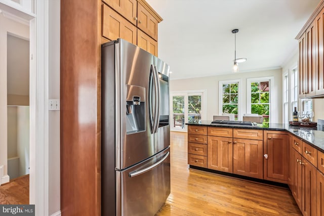 2227 N Albemarle St, Arlington, VA 22207 - kitchen featuring stainless steel fridge with ice dispenser, light wood-style floors, gas cooktop, brown cabinetry, and crown molding