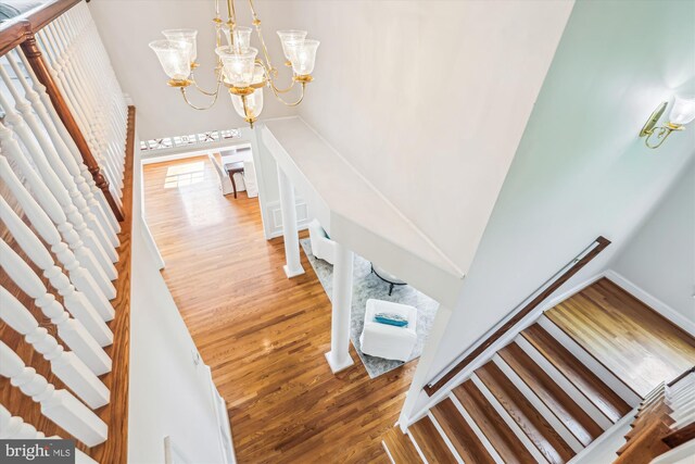 2227 N Albemarle St, Arlington, VA 22207 - stairs with wood finished floors, a chandelier, and baseboards