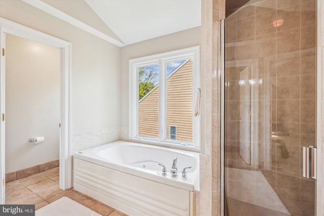 2227 N Albemarle St, Arlington, VA 22207 - bathroom with vaulted ceiling, a bath, a shower stall, tile patterned floors, and baseboards