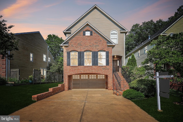 2227 N Albemarle St, Arlington, VA 22207 - traditional-style home with brick siding, a garage, concrete driveway, a yard, and stairway