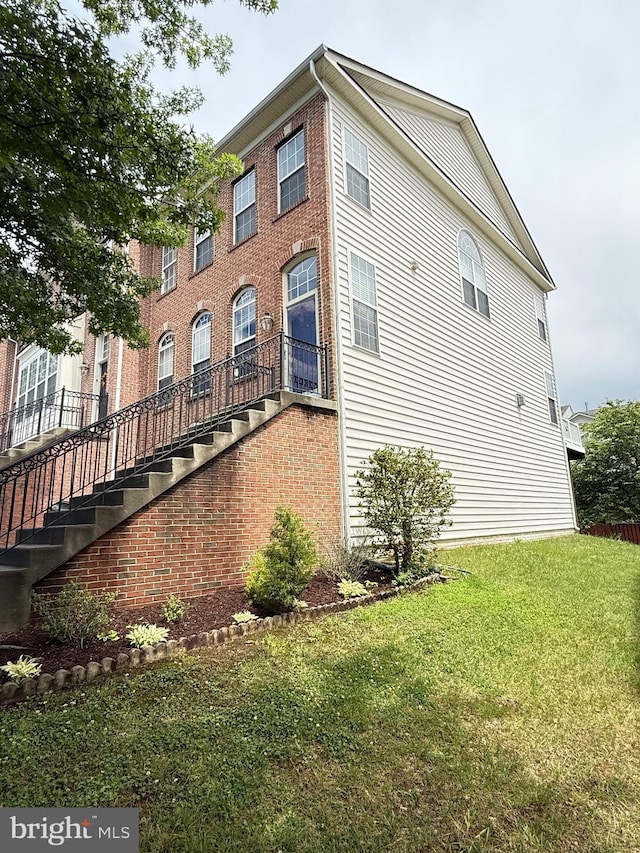 16321 Flotsam Ln, Woodbridge, VA 22191 - view of property exterior with stairs, a lawn, and brick siding